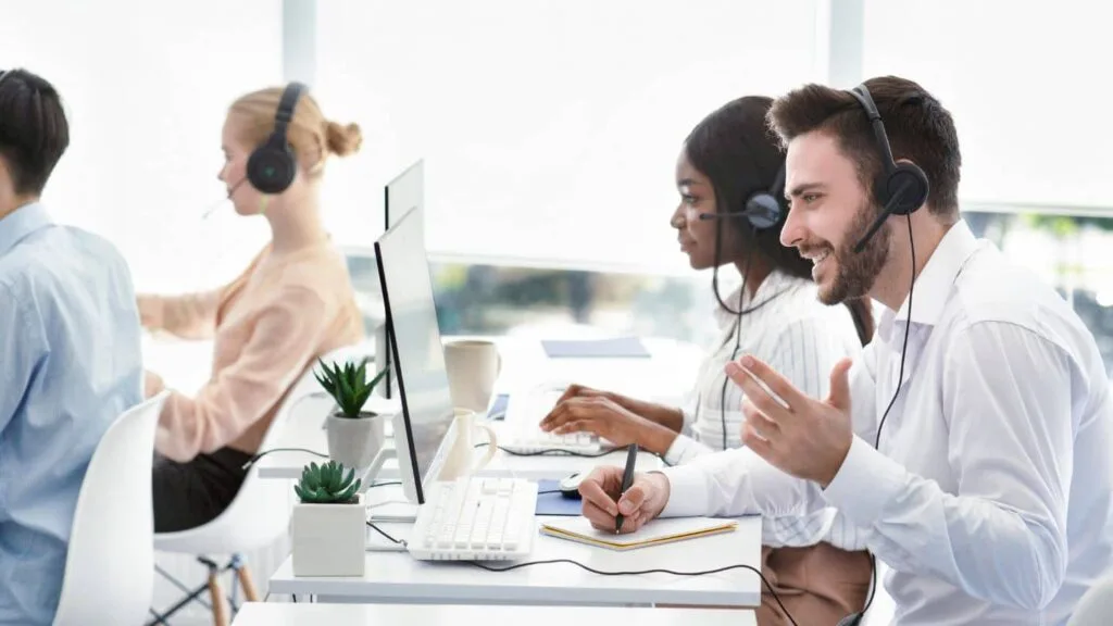 A group of employees making phone calls through a VoIP system