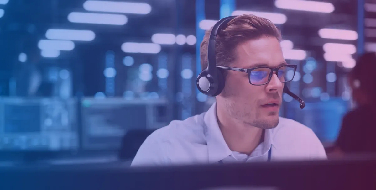 Technician with headset working at an IT support center